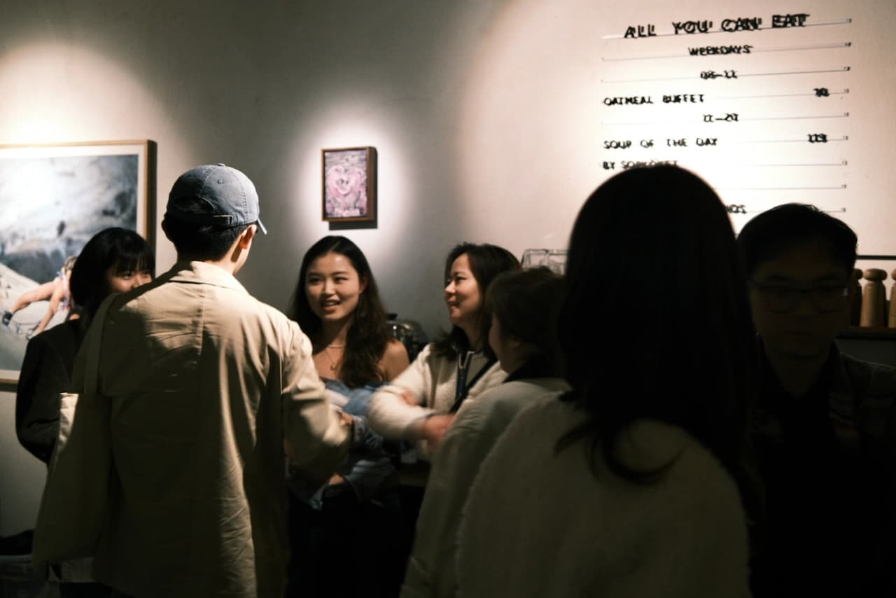 People chatting together at a café gathering.